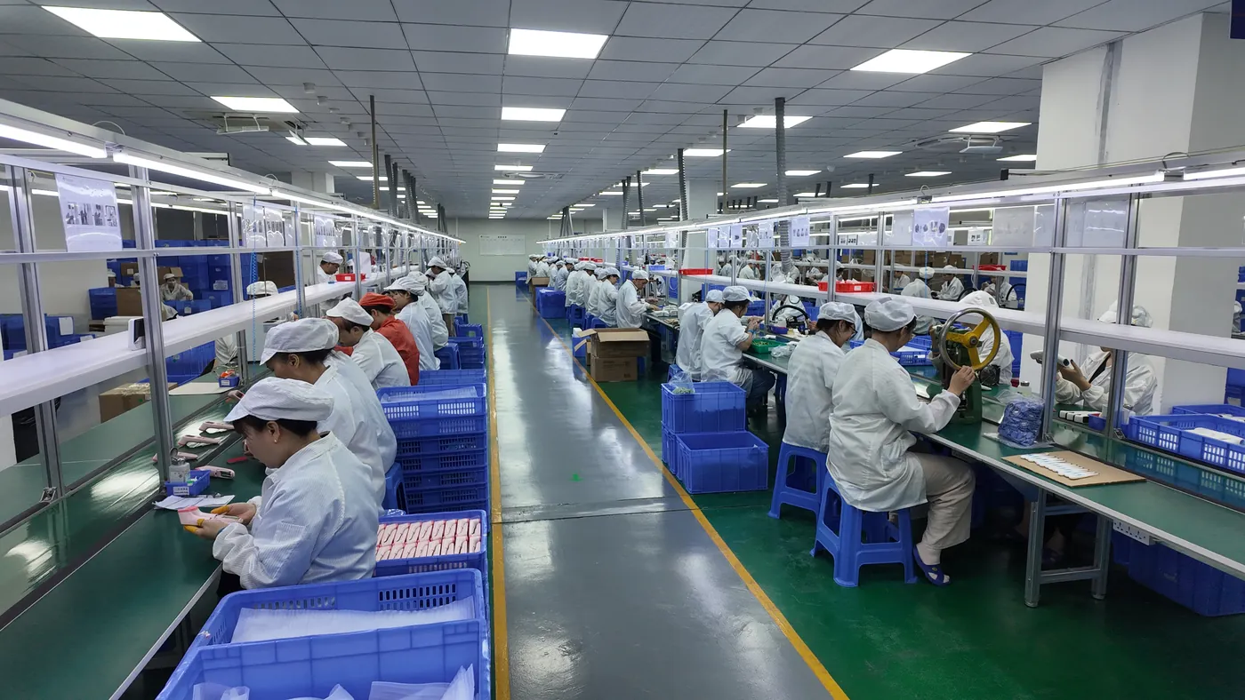 Operators assembling devices on the production line